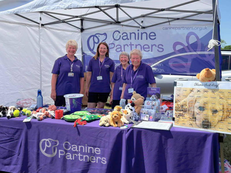 Group of people manning the Canine partners stand at a community event