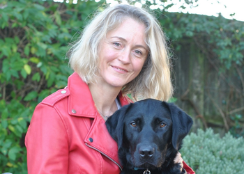 Lady sat with black Labrador