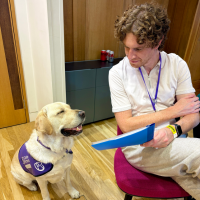 Dog smiling at a man holding a clipboard