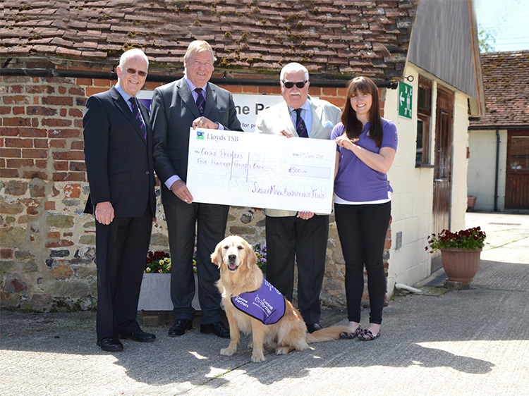 Sussex Benevolent Fund cheque presentation with staff and meet and greet dog Jenson