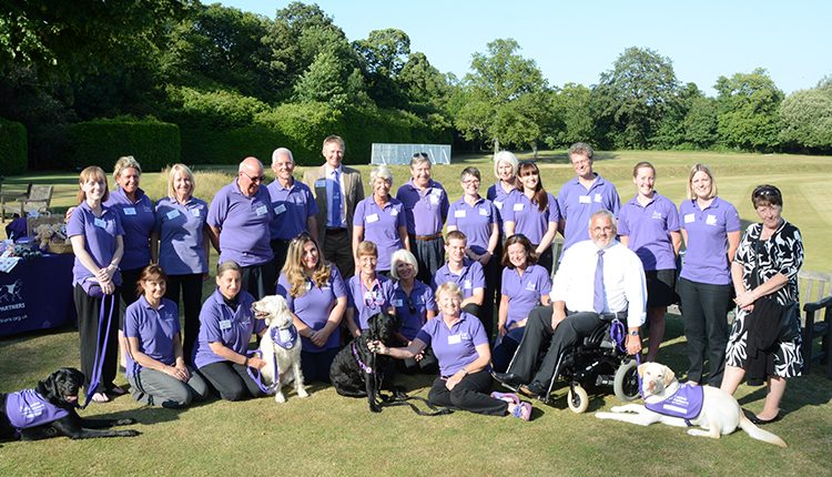 Canine Partners staff, volunteers and partners posing in Arundel