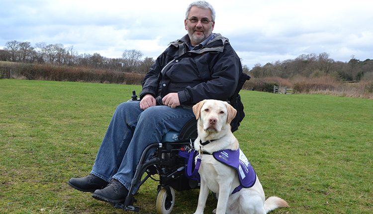 Martin and assistance dog Keith on South Downs field