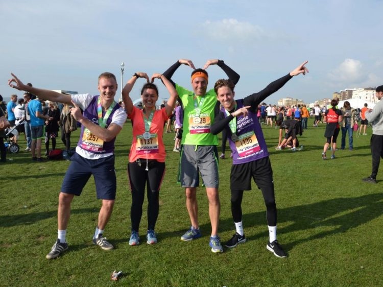 Rob Barston, Elly Mcmeehan, Todd Phillips and John Hearn with their finishers medals at Brighton10 in aid of Canine Partners
