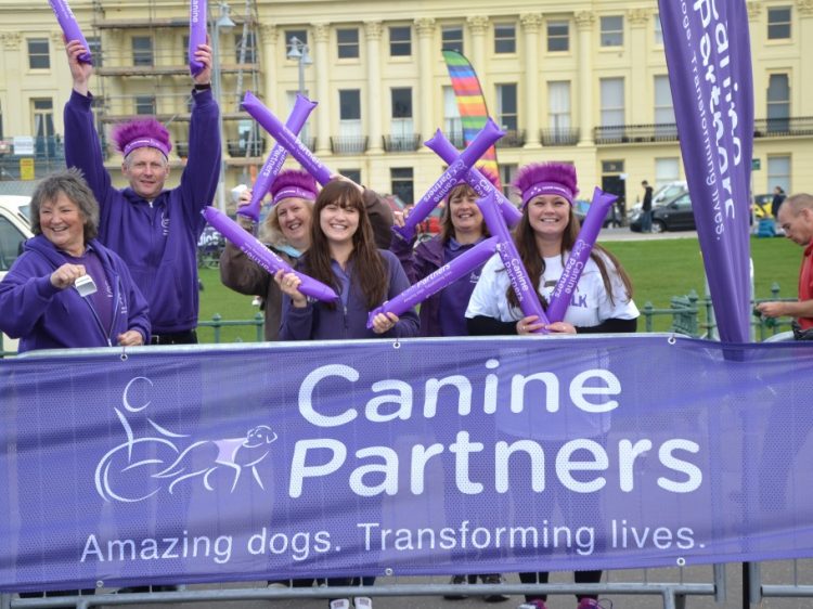 Staff and volunteers cheering on the Canine Partners runners at Bright10