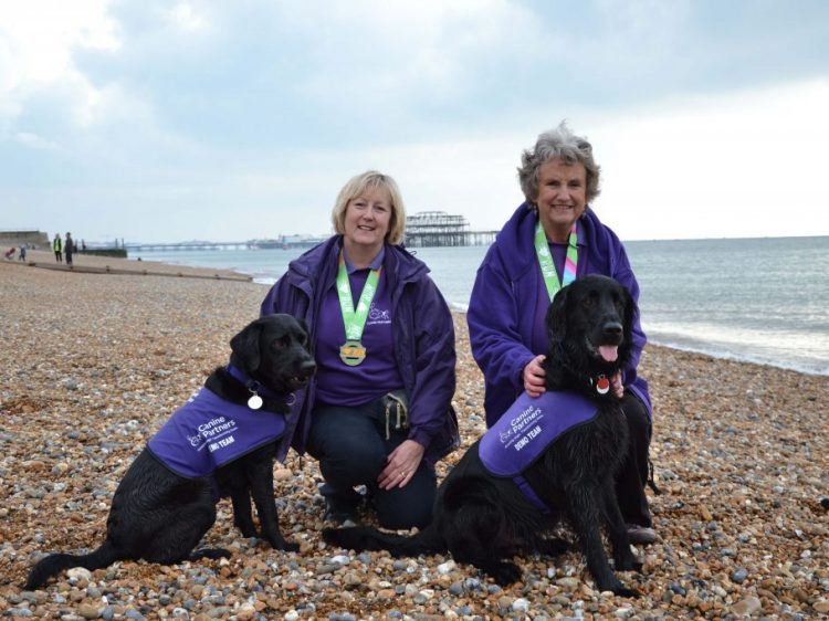 Volunteers Ali and Sarah with demo dogs Yarna and Hamlet on Brighton beach