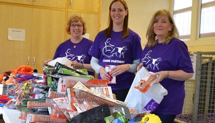 Purina volunteers packing goody bags for Canine Partners