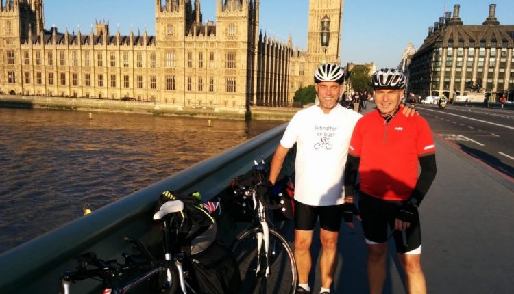 Two cyclists posing in front of Big Ben, part way through Clock to Rock cycling challenge