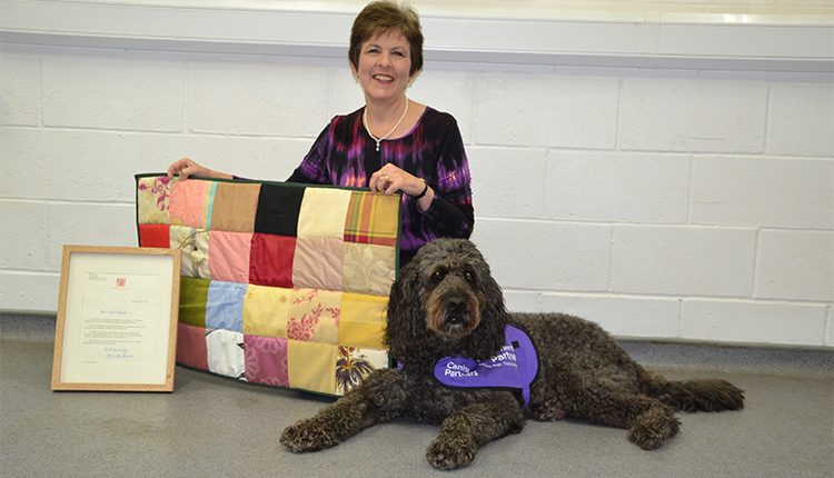 Olive holding textile art with demo dog Doyle