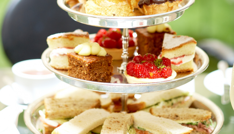 Afternoon tea cakes and sandwiches on a silver stand