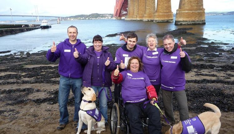 Team of Canine Partners fundraisers under Forth Rail Bridge in Scotland