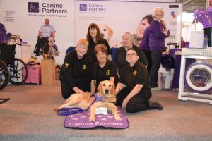 Tail Waggers Display Team present Canine Partners demonstration dog Blythe with a cheque for £500