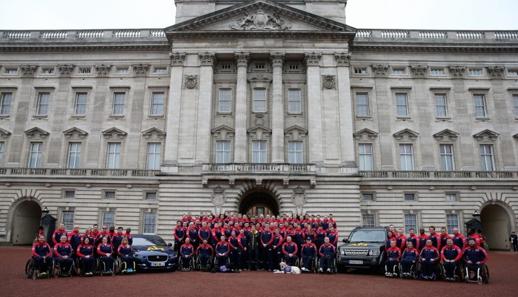 Prince Harry with UK 2016 Invictus Games team including two Canine Partners partnerships outside Buckingham Palace