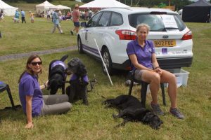 Claire Anthony, with canine partners Kerry and Doyle, and Julia Chase with Taylor sat down at summer fete
