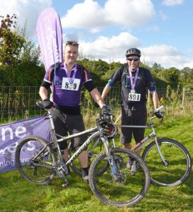 Two cyclists with their medals at Pedal for Paws cycling event in West Sussex