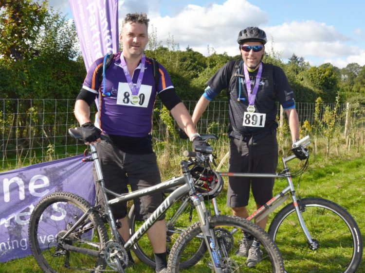 Two cyclists with their medals at Pedal for Paws cycling event in West Sussex