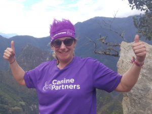 Fundraiser Julie on top of Macchu Pichu fundraising for Canine Partners
