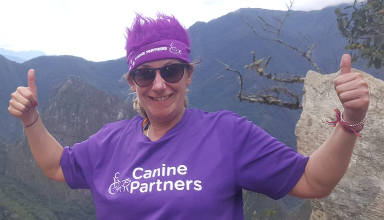 Fundraiser Julie on top of Macchu Pichu fundraising for Canine Partners