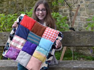 Young pupil Megan with her Textile Art Challenge piece in aid of Canine Partners