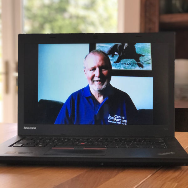 A Canine Partners' virtual talk displayed on a laptop